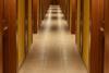 Turned-on lights along hotel hallway