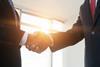 dealmakers handshake with sun coming through window rs 2