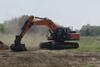Excavator leveling ground