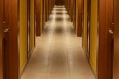 Turned-on lights along hotel hallway