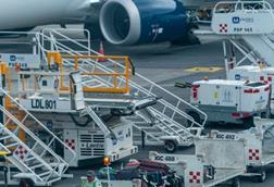 Ground Crew Driving Vehicle with Baggage on Tarmac