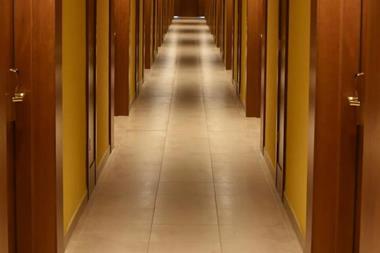 Turned-on lights along hotel hallway