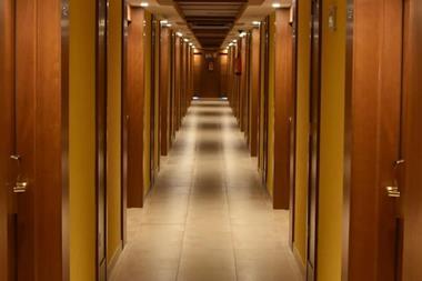 Turned-on lights along hotel hallway