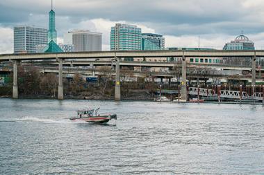 A boat on a river with the view of the City of Portland, Oregon