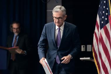 federal reserve chairman jerome powell approaches reporters having made the first interest rate cut in several years