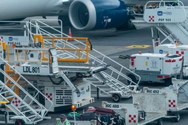 Ground Crew Driving Vehicle with Baggage on Tarmac