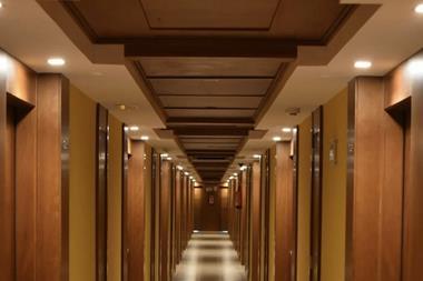 Turned-on lights along hotel hallway