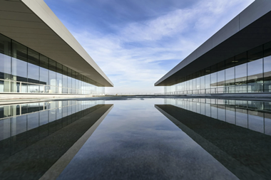 White building reflecting on water