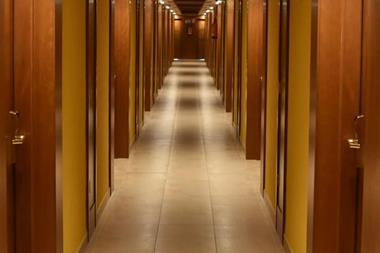 Turned-on lights along hotel hallway