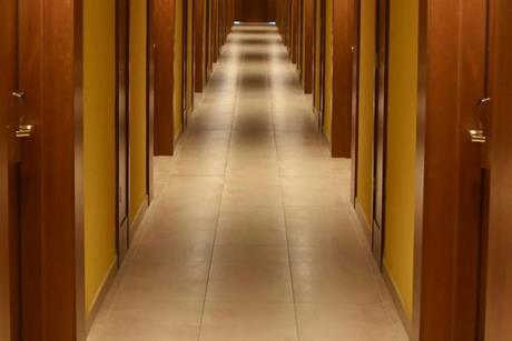 Turned-on lights along hotel hallway