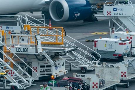 Ground Crew Driving Vehicle with Baggage on Tarmac