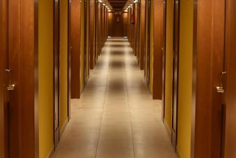 Turned-on lights along hotel hallway