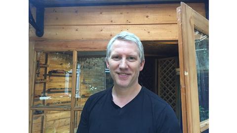 Robin Marriott in front of his garden summer house
