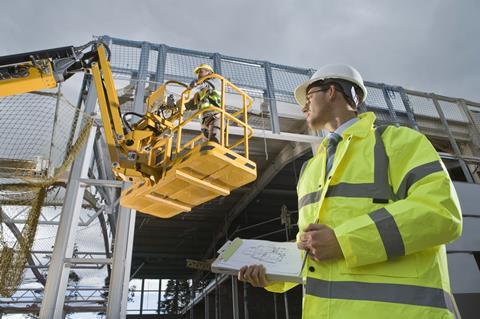 development superviser in hard hat man in cherrypicker
