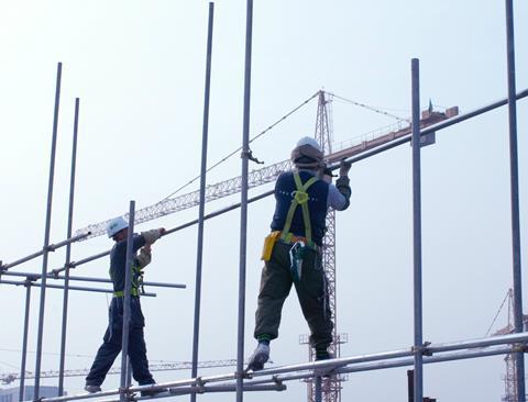 development construction workers on scaffolding rs