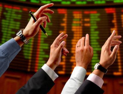 hands in air screen behind stock exchange rs