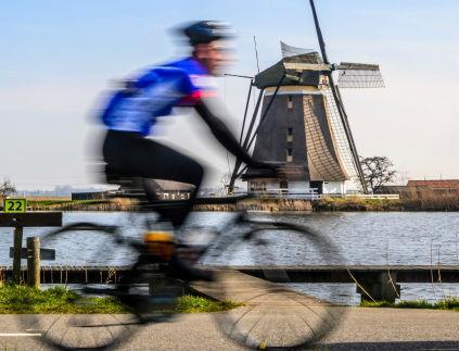 cyclist blurred windmillrs